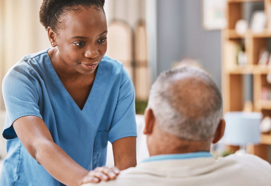 Nurse comforting elderly patient